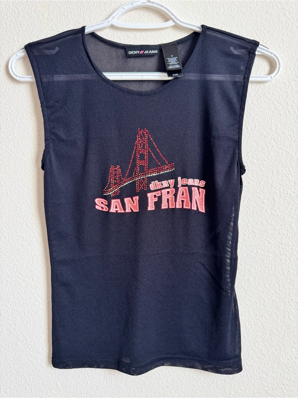 DKNY sheer black top with San Francisco design and sparkly red dots. M (fits S)